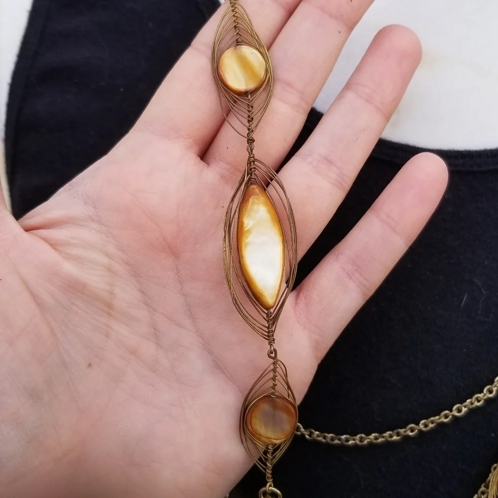 layered gold tone chain necklace with dyed shell accents